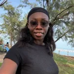 Patricia Zubair MPP Student smiling under trees at nightcliff foreshore