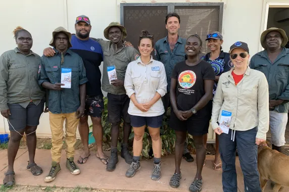 group of rangers and researchers standing outside a building